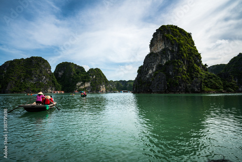 Halong bay in Vietnam, UNESCO World Heritage Site, with tourist rowing boats