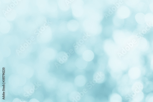 Natural spring blurred blue sea background. Create light soft blurred colors bright sunshine. Blue bokeh abstract glitter light background. Focus texture from nature fresh shiny growth seas the day.
