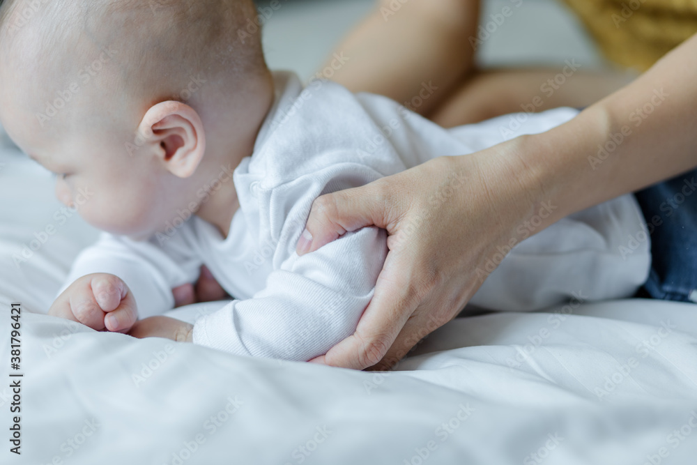 Happy mom and baby playing together on the bed at home . family love concept. Happy mom and baby playing together on the bed at home . family love concept.