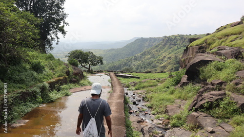 a person walking on a river in mointains