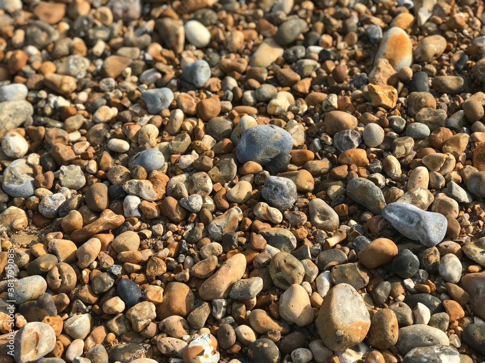Abstract multi-colored pebbles in beach, natural background and texture. Close-up texture of stones and rocks. Abstract multi-colored pebbles in beach, natural background and texture. Close-up texture of stones and rocks.