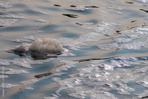 Foam floating in river water