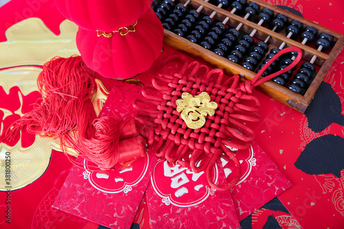 Red envelope and Chinese knot and abacus and lantern on red spring couplet background