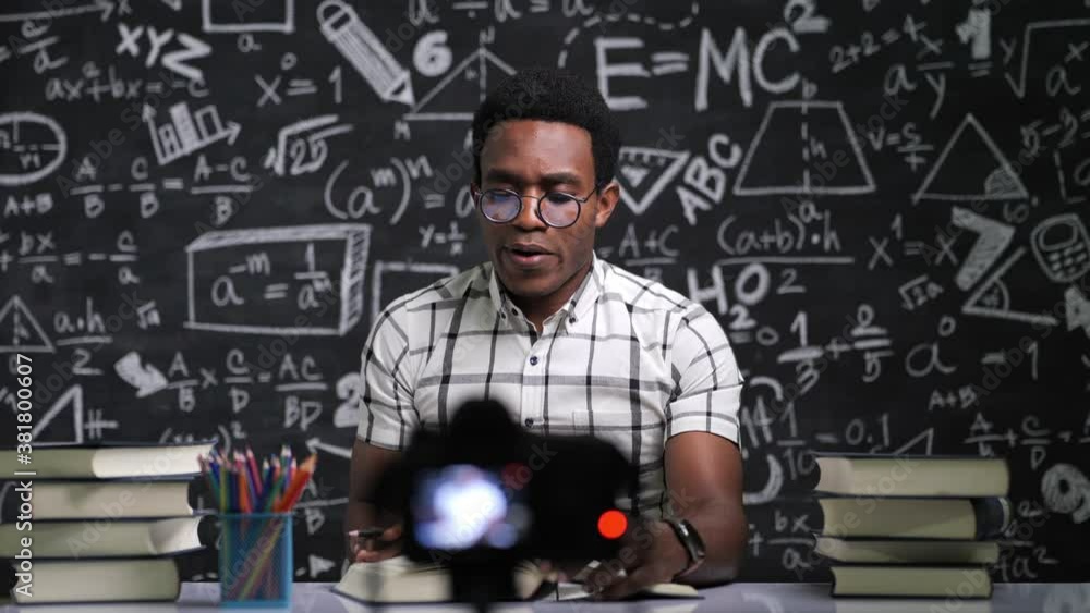 Young African teacher doing lesson online with a camera at home Young African teacher doing lesson online with a camera at home