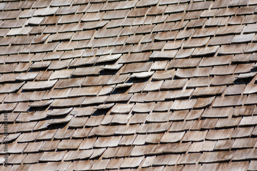 Elevated view of traditional wooden shingle roof with a few damaged shakes Elevated view of traditional wooden shingle roof with a few damaged shakes