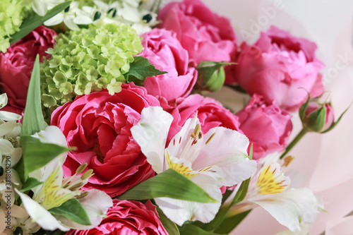 Pink-green bouquet of roses  white lilies  hydrangeas on a purple background