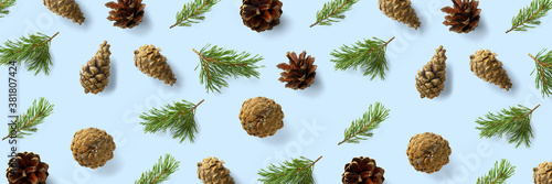 Pine cone Christmas background on blue. Pine branches and cones. minimal creative cone arrangement pattern. flat lay  Modern christmas Background.