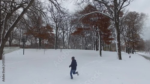 guy running in the snow in minnesota during winter time photo