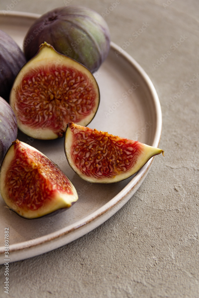Fresh figs on a plate on a light concrete background Fresh figs on a plate on a light concrete background