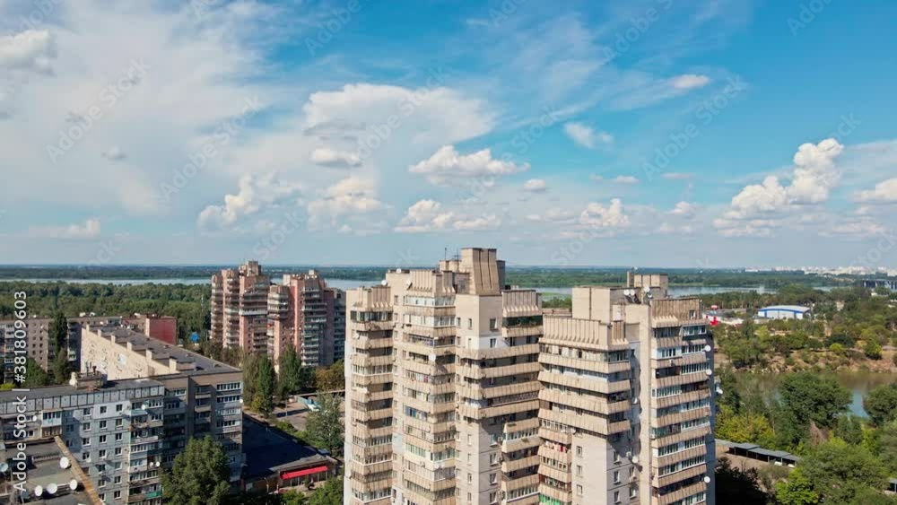 drone flight over roofs of multi floor buildings district in city outskirts with large green parks and big river, Dnipro, Ukraine drone flight over roofs of multi floor buildings district in city outskirts with large green parks and big river, Dnipro, Ukraine
