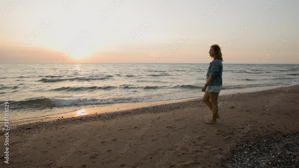 Young woman enjoys Summer sunset at sea Young woman enjoys Summer sunset at sea
