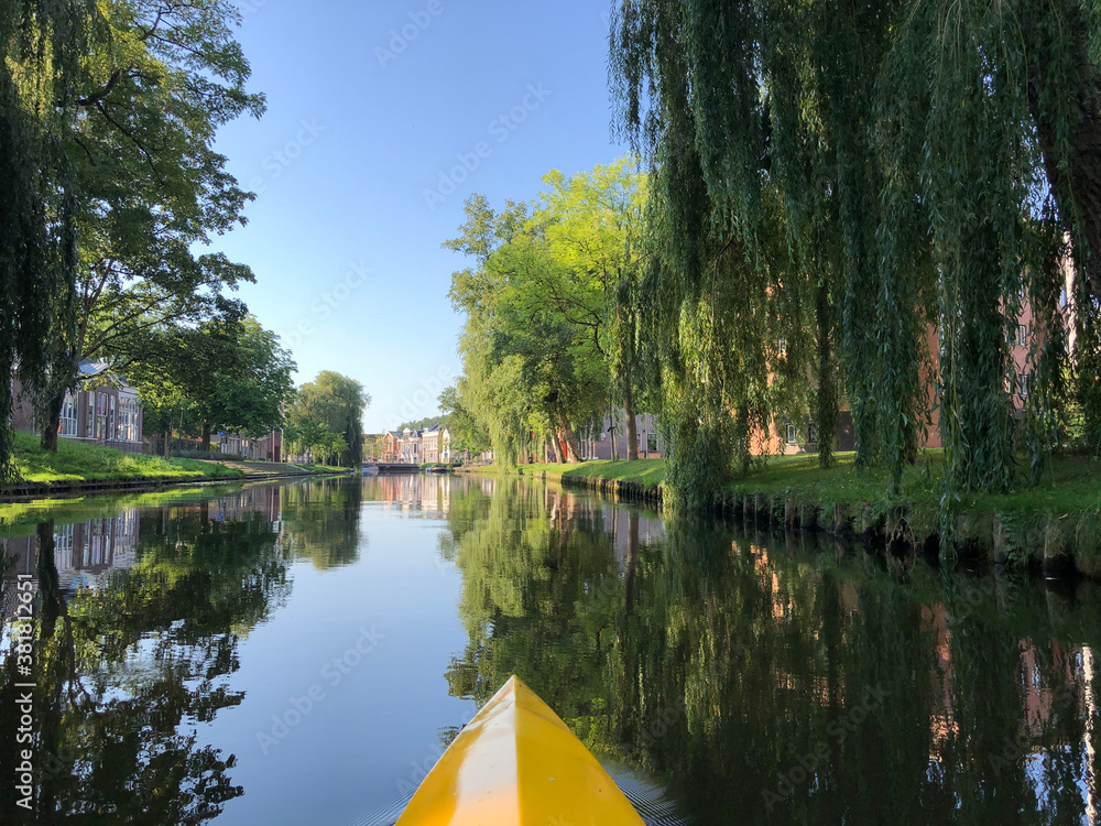 Naklejka premium Canoeing at the canal around the old town of Sneek