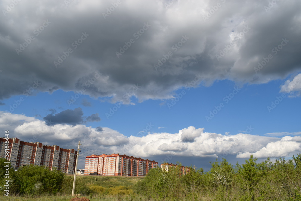 blue sky with clouds over houses blue sky with clouds over houses