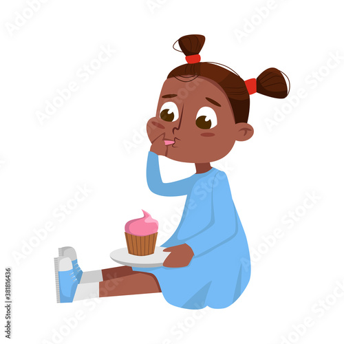 Принти на полотні Cute African American Girl Sitting on Floor Eating Cupcake, Kid Enjoying Eating