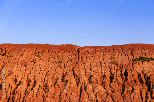 Red Rough Geological Formation Detail with blue sky. Natural canyon backgrounds and textures