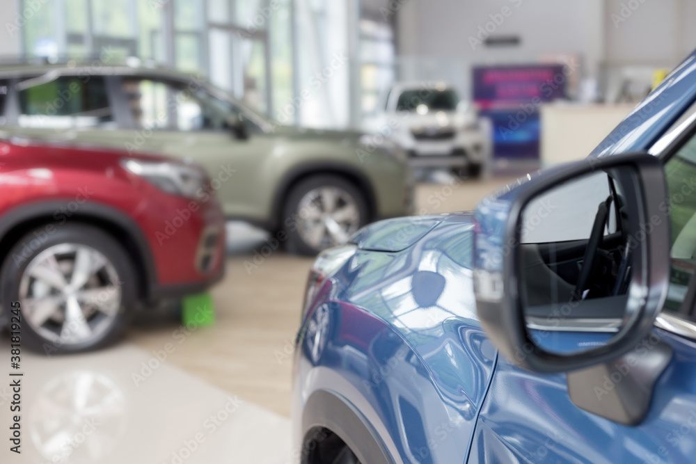 New cars at dealer showroom. Themed blur background with bokeh effect. Car auto dealership.
