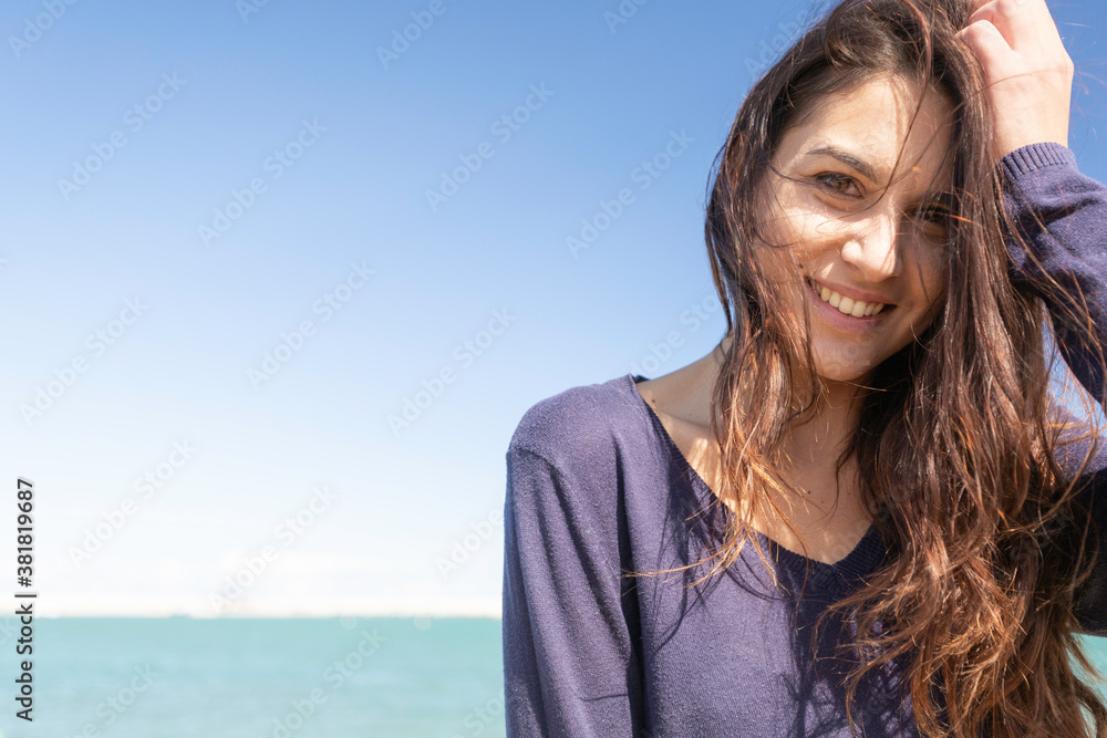 Close-up of a beautiful young italian woman with long dark hair as she looks into the camera Close-up of a beautiful young italian woman with long dark hair as she looks into the camera