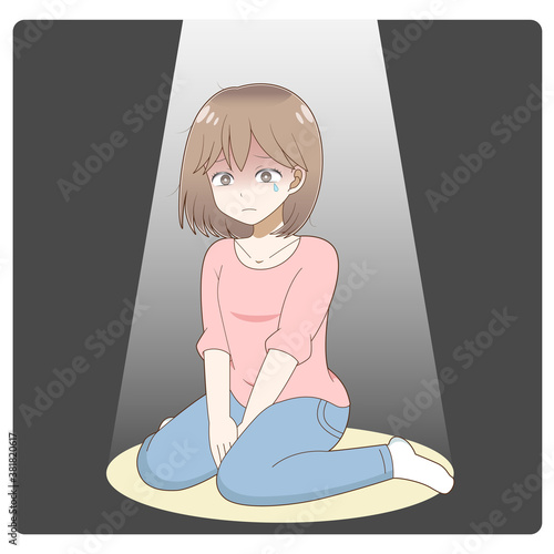 スポットライトに照らされながら悲しむ女性