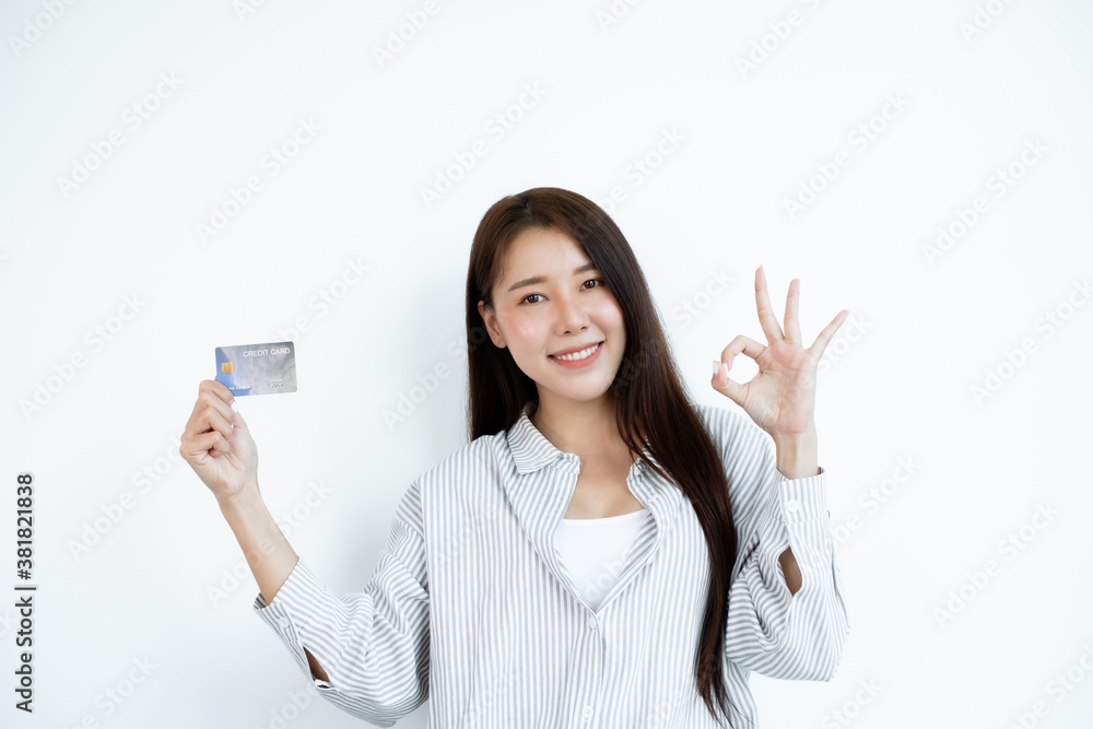 The hand of an Asian woman holding a credit card is used for online shopping and Internet payments The hand of an Asian woman holding a credit card is used for online shopping and Internet payments