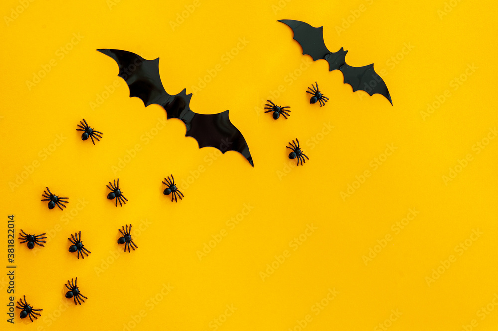 The backdrop for Halloween. On an orange background are black spiders and bats. A place for text. The backdrop for Halloween. On an orange background are black spiders and bats. A place for text.