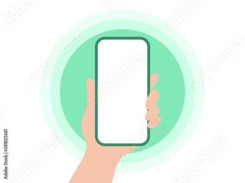 Hand holding a mobile phone on green background