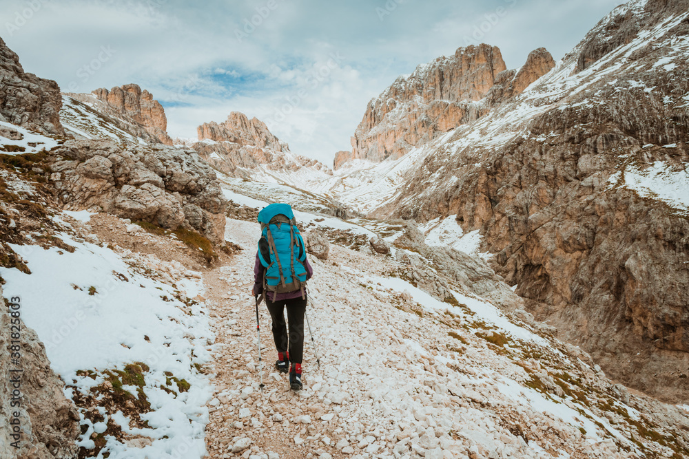 One middle aged woman hiking in mountains, Dolomites Italy