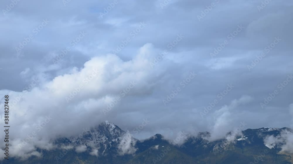 Time lapse clouds covering Alps mountains. Amazing nature in Slovenia. Water evaporates from the ground. Static shot, wide angle, 4K Time lapse clouds covering Alps mountains. Amazing nature in Slovenia. Water evaporates from the ground. Static shot, wide angle, 4K