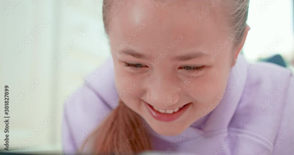 Teen girl is smiling when touches the tablet Teen girl is smiling when touches the tablet