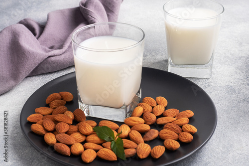 Stampa su Tela Almond milk in glass glasses on a gray background. Copy space.