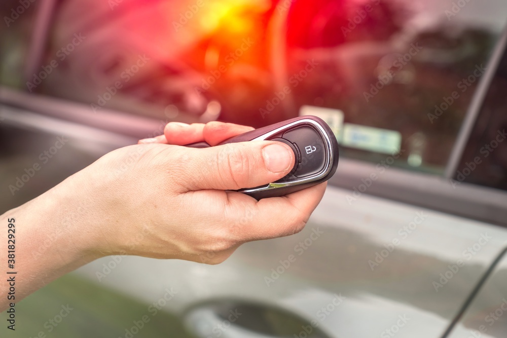 Fototapeta premium Woman lock or unlock her car with car remote control