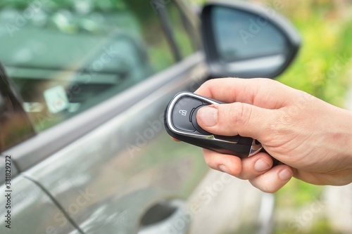Woman lock or unlock her car with car remote control
