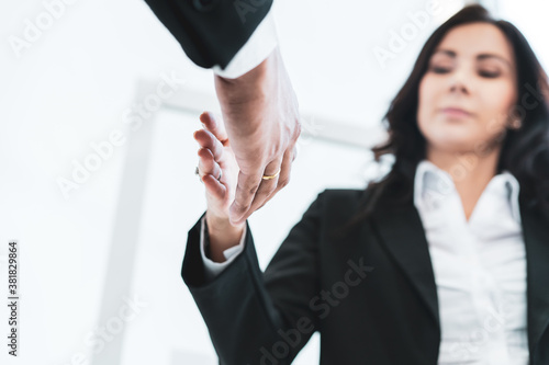 Asian and caucasian ethnicity businesspeople doing a handshake together after done and completed business negotiation. Trust in business partnership and colleague. Successful in business concept. © DG PhotoStock