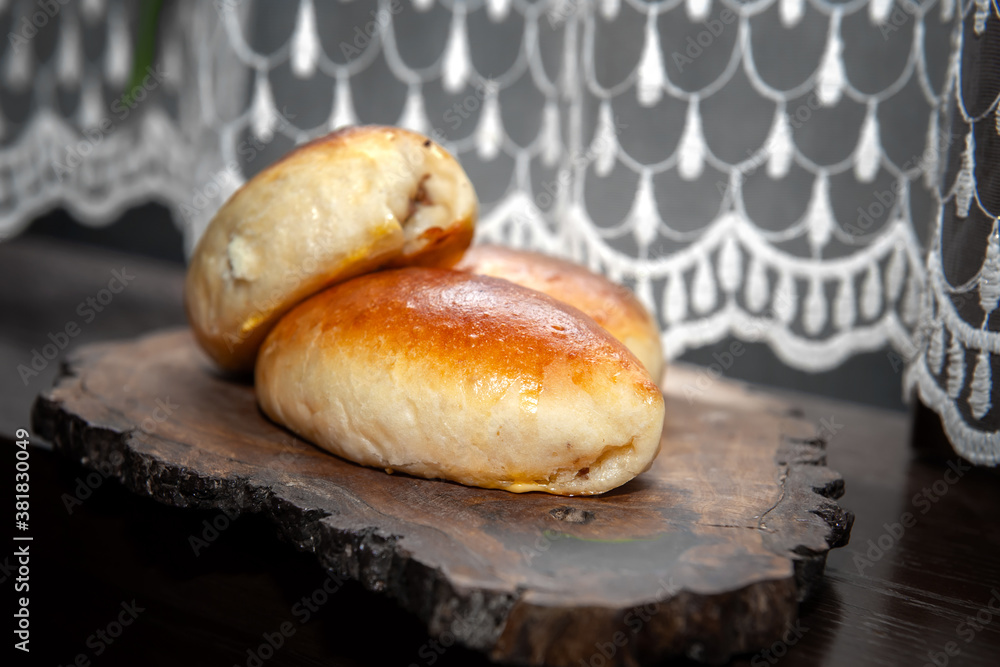 Freshly baked pies on a glass stand with a napkin. Close-up of baked pies