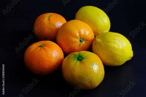 Lemon and orange in dark background