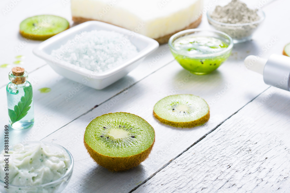 beauty products with kiwi fruit ingredient on white wooden table beauty products with kiwi fruit ingredient on white wooden table