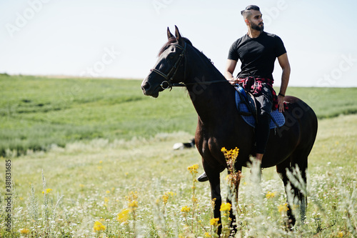 Arab tall beard man wear in black ride arabian horse. © AS Photo Family