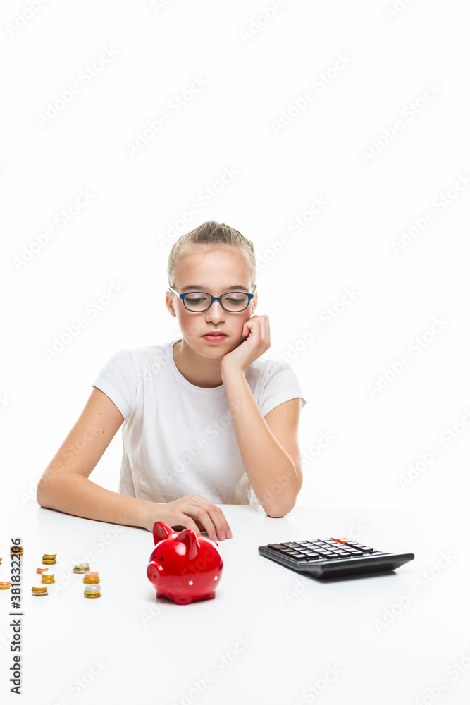 Portrait of Teenage Girl Posing With Coins and Moneybox. Calculating Income With Calculator. Portrait of Teenage Girl Posing With Coins and Moneybox. Calculating Income With Calculator.
