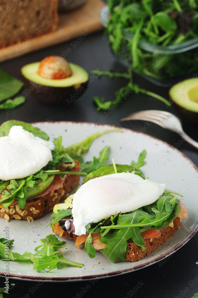 Homemade sandwiches with salmon, avocado and poached eggs