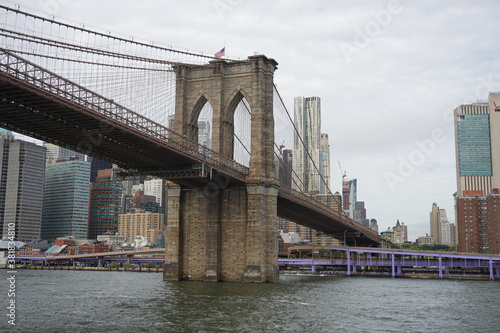 Looking up at the Brooklyn Bridge on the river