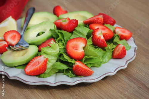 Fresh salad with strawberries,avocado and lettuce