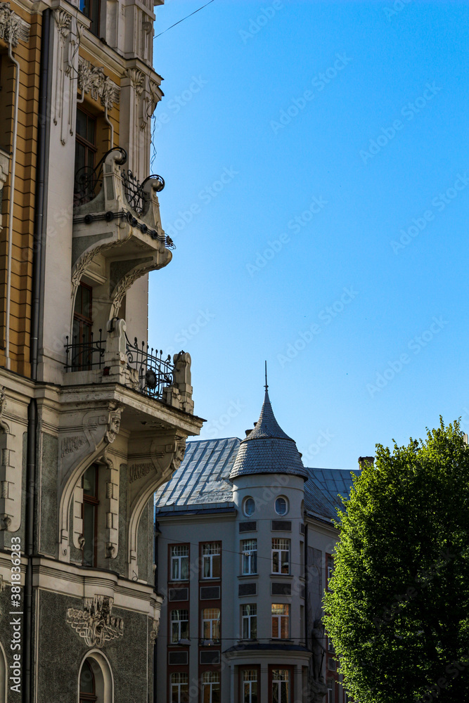 Exteriors of old buildings with balcony and decorations