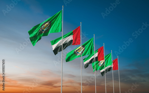 Waving flags of Gulf Cooperation Council of the Persian Gulf States - Bahrain, Kuwait, Oman, Qatar, Saudi Arabia, and the United Arab Emirates - except Iraq at sunset sky background. GCC photo