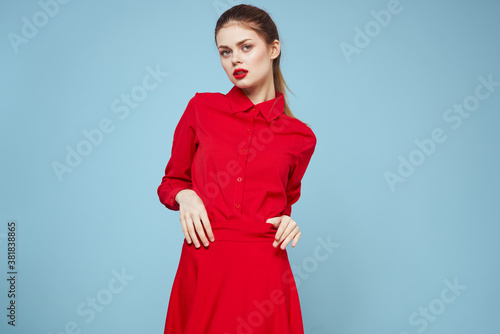attractive woman in bright clothes on blue background gesturing with hands and red lips makeup cropped view emotions