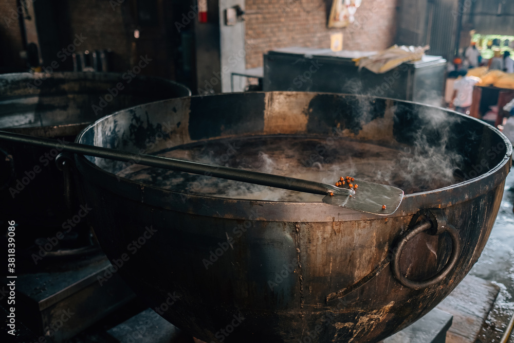 Amritsar, India - Cooks preparing food portion for pilgrims. The Kitchen at Golden Temple Feeds up to 100,000 People a Day for Free - Harmandir Sahib, Amritsar, India. Amritsar, India - Cooks preparing food portion for pilgrims. The Kitchen at Golden Temple Feeds up to 100,000 People a Day for Free - Harmandir Sahib, Amritsar, India.