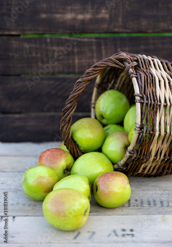 Healthy organic apples in a basket on a wooden background. The concept of a healthy diet.