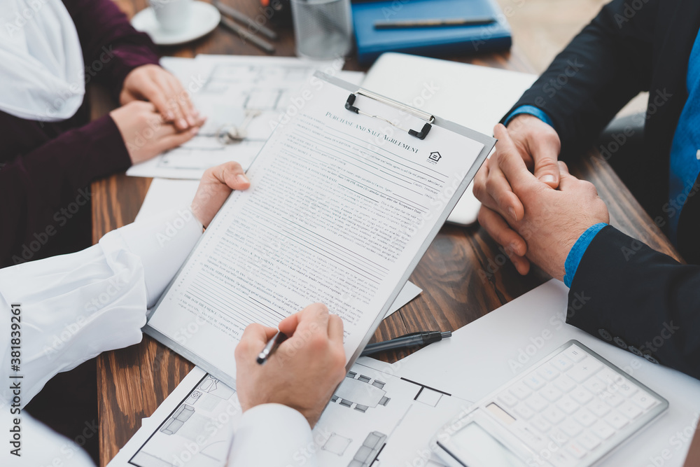 A man fills out contract while sitting in office. A man fills out contract while sitting in office.