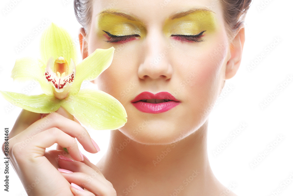 young woman with bright make up holding orchid young woman with bright make up holding orchid