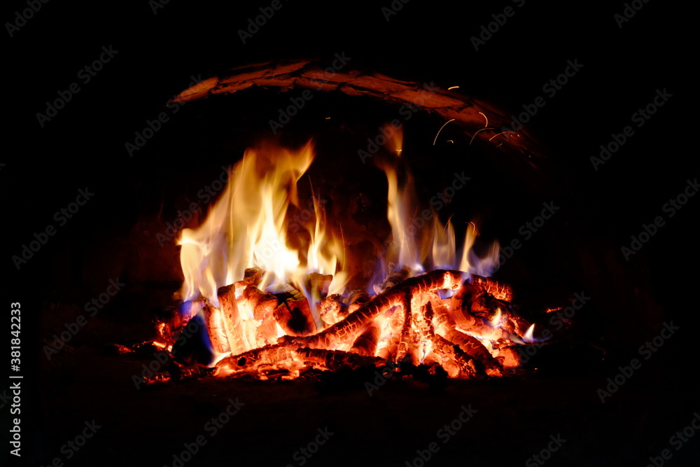 Logs burning in the oven. Flames and heat on the wood. Hot logs. Logs burning in the oven. Flames and heat on the wood. Hot logs.