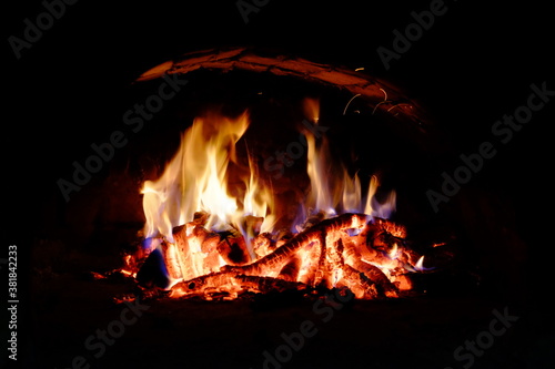 Logs burning in the oven. Flames and heat on the wood. Hot logs.