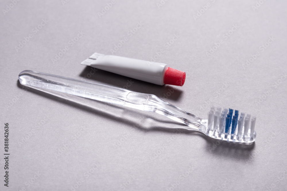Single use disposable toothbrush with small tube of toothpaste Single use disposable toothbrush with small tube of toothpaste